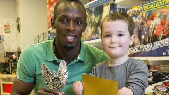Six-times Olympic gold medallist Usain Bolt with Pride of Britain Award winner, Harley Lane.