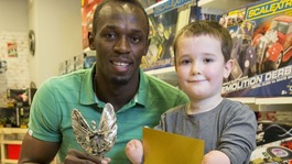 Six-times Olympic gold medallist Usain Bolt with Pride of Britain Award winner, Harley Lane.