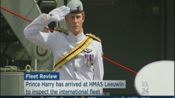 Prince Harry salutes at the HMAS Leeuwin to inspect the international fleet.