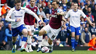 Cardiff City's Aron Gunnarsson and West Ham United's Mark Noble battle for the ball