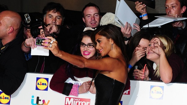 Nicole Scherzinger took time to take pictures with fans on the red carpet.