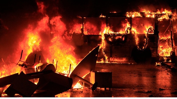 A bus burns after it was set on fire during demonstrations in the capital