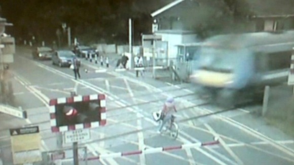 CCTV pictures show the cyclist with the fast moving train approaching