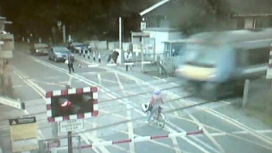 CCTV pictures show the cyclist with the fast moving train approaching