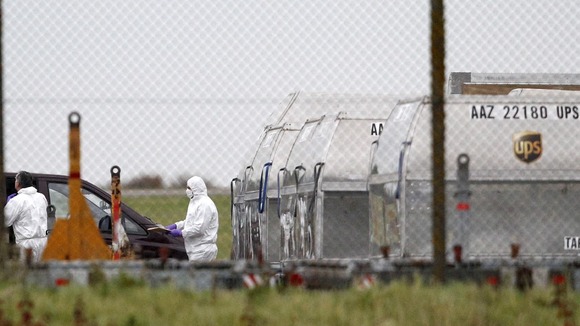 A forensic officer removes a package from a UPS container at East Midlands Airport in 2010.