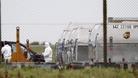 A forensic officer removes a package from a UPS container at East Midlands Airport in 2010.