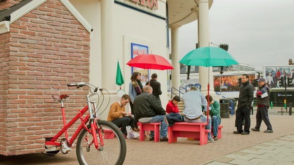 Crowds gather outside a bingo hall in front of the mobile square