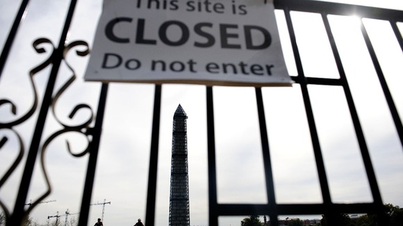 The Washington Memorial in Washington, DC, with a 'This site is closed, do not enter' sign.