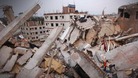 Men attempt to rescue the garment workers from the rubble of the collapsed Rana Plaza building