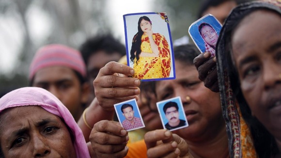 Relative show pictures of garment workers who are missing