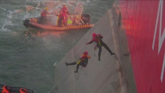 Activists rappel from a Russian oil rig in the Arctic