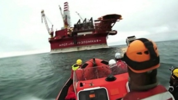 A Greenpeace vessel approaches the oil rig