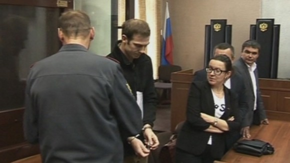 Kieron Bryan is led out of the dock in a Russian court in hand cuffs