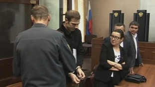 Kieron Bryan is led out of the dock in a Russian court in hand cuffs