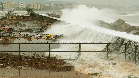 Waves crash onto the shore at a fishing harbour in Visakhapatnam district.