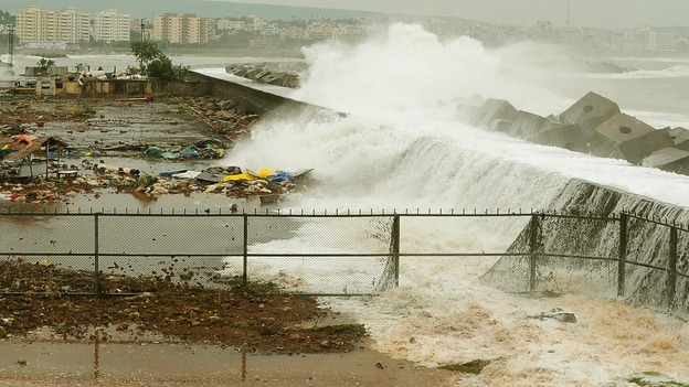 Waves crash onto the shore at a fishing harbour in Visakhapatnam district.