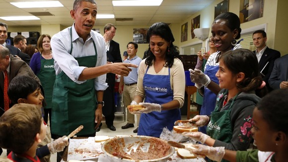 President Barack Obama greets children and volunteers at Martha's Table in Washington.