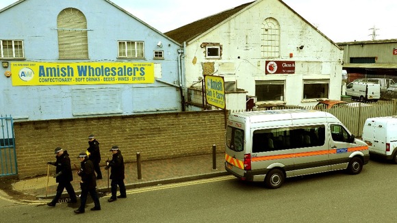 Police Officers and van outside the Glen Cash & Carry warehouse in Barking
