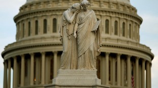 The statue of Grief and History stands in front of the Capitol Dome in Washington.