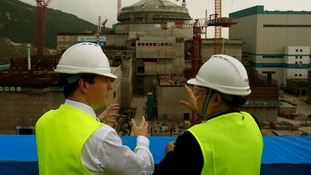 Chancellor George Osborne (L) visits a nuclear power plant under construction in Taishan, Guangdong province