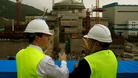Chancellor George Osborne (L) visits a nuclear power plant under construction in Taishan, Guangdong province