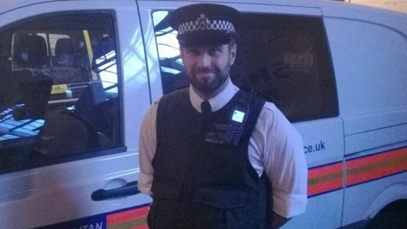 PC Robert Morgan poses for the camera at the end of his shift.