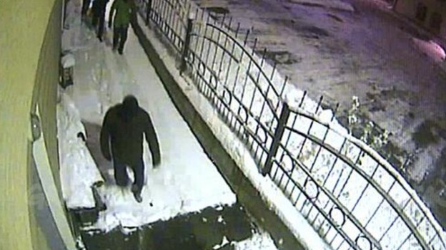 The masked men are seen entering Greenpeace's building in Murmansk