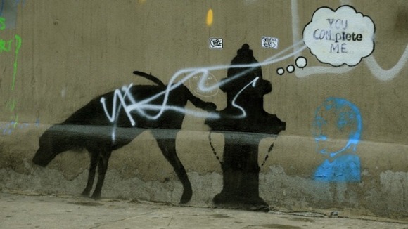 A street art graffiti by elusive British artist Banksy is seen on a wall in New York.