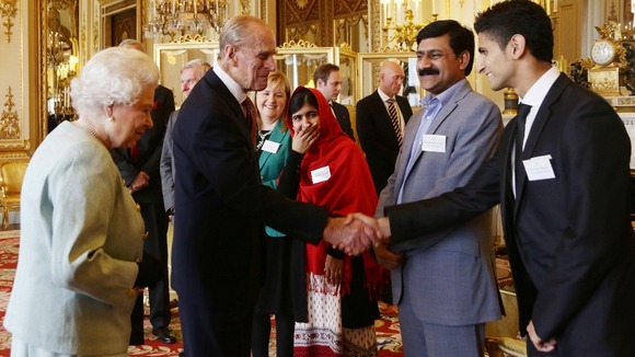 The Duke of Edinburgh makes Malala giggle with a joke.