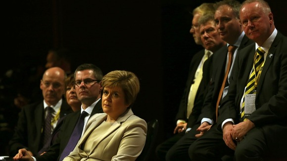 Deputy leader Nicola Sturgeon watches as party leader Alex Salmond delivers his address