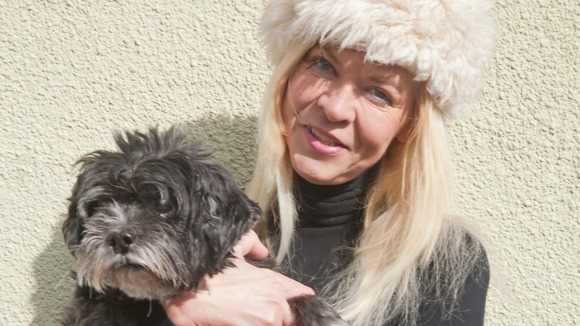 Jayne holding a grey dog