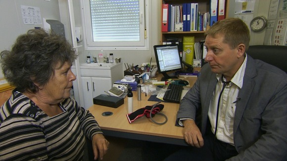 Doctor sits with a patient