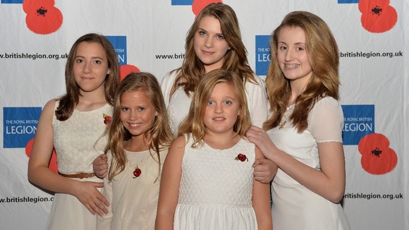 The Poppy Girls pose for a photograph before a concert at RAF Northolt to launch the Royal British Legion's Poppy Appeal 2013.