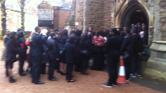 Mourners file into the church