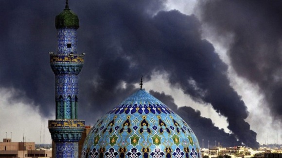 Shahid Mosque photographed against a backdrop of oil fires. The fires were lit by Iraqis in an attempt to confuse Coalition bombers.
