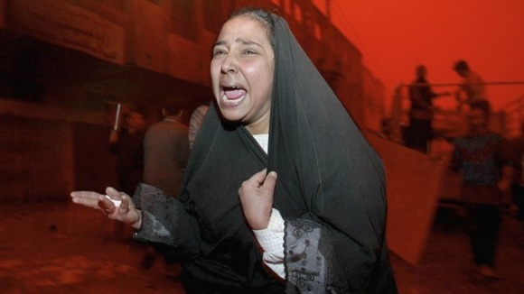 An Iraqi woman is distraught after a missile strike on a street market killed her husband in the Al Shabab district.