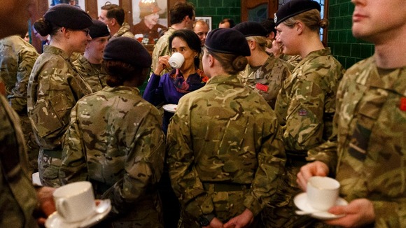 Aung San Suu Kyi joins officer surrounded by female cadets at the Royal Military Academy Sandhurst.