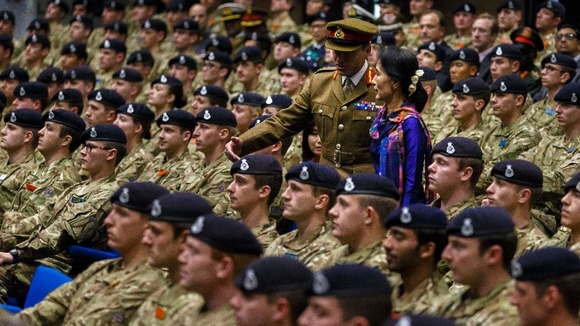 The Burmese opposition leader and Camp Commandant Major General Stuart Skeates arrive to deliver a speech at Sandhurst