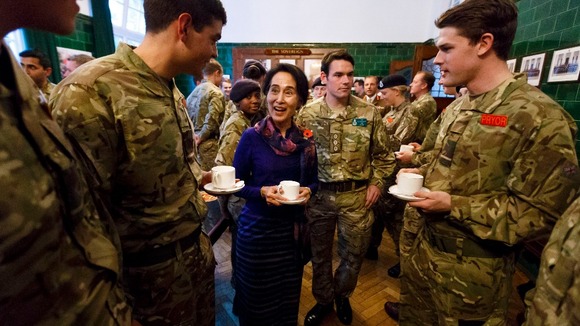 Burmese opposition leader Aung San Suu Kyi jokes with officer cadets over a cup of tea at the Royal Military Academy Sandhurst.