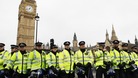 Police officers form a line in front of the Houses of Parliament as student protesters gathered nearby in central London November 30, 2010