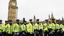 Police officers form a line in front of the Houses of Parliament as student protesters gathered nearby in central London November 30, 2010