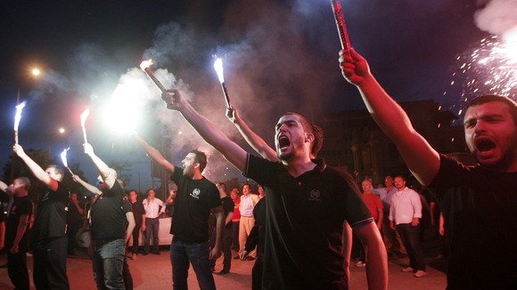 Supporters of the extreme-right Golden Dawn party raise flares as they celebrate polls results in Thessaloniki