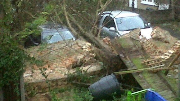 Cars under a collapsed wall in London