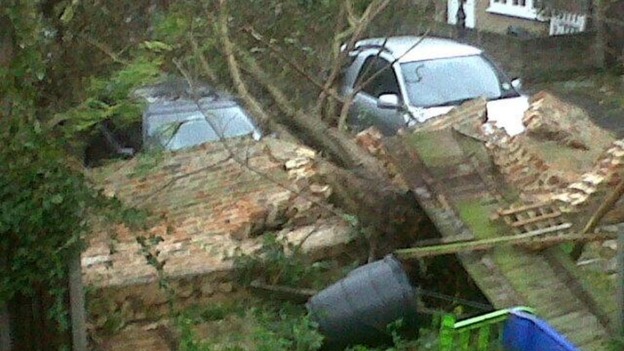 Cars under a collapsed wall in London