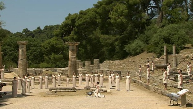 The flame is lit in front of the ancient ruins of the Temple of Hera