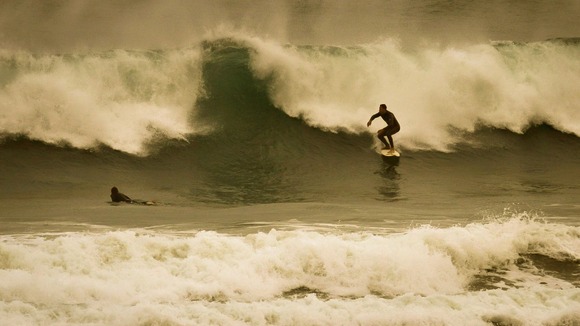 Surfers make the most of huge waves in Newquay, Cornwall