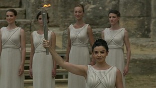 The "high priestess" lights the Olympic flame.