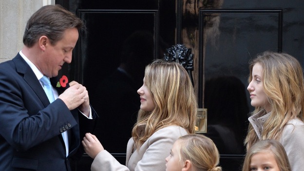 David Cameron poses with The Poppy Girls outside 10 Downing Street, ahead of the Royal British Legion's 2013 Poppy Appeal.
