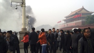 Smoke rises in front of the main entrance of the Forbidden City at Tiananmen Square.