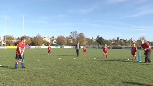 Children playing cricket in Cambridge.